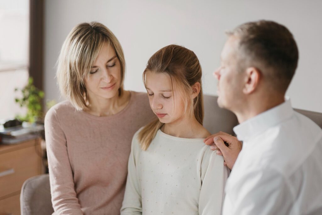 A young child with a primary caregiver, showing signs of attachment disorder